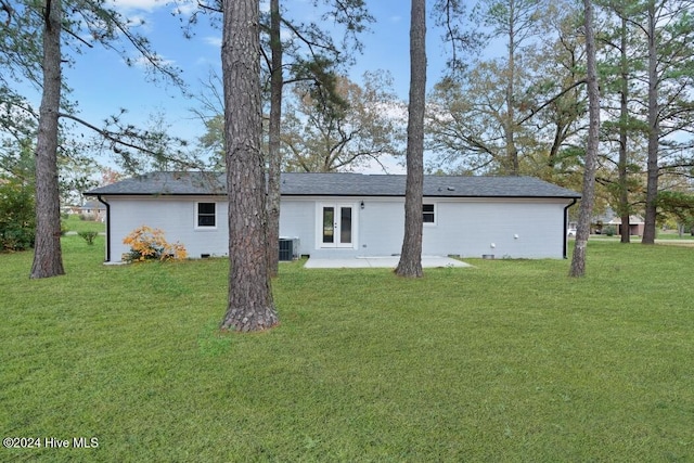 back of house featuring french doors, central AC unit, a patio area, and a lawn