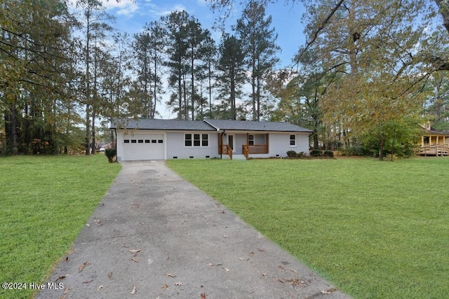 ranch-style house featuring a garage and a front lawn