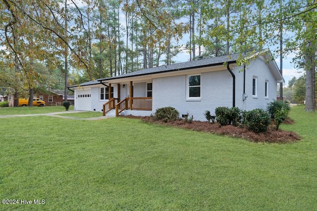 single story home featuring a front yard, a garage, and covered porch