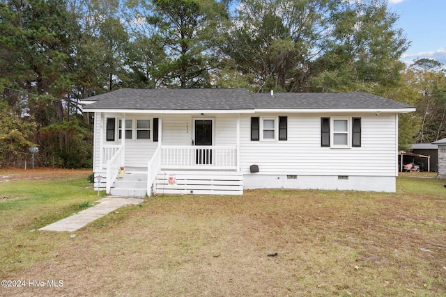 view of front of property with covered porch and a front yard