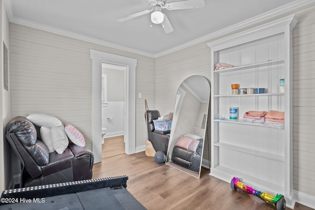 interior space featuring wood-type flooring, ceiling fan, and ornamental molding