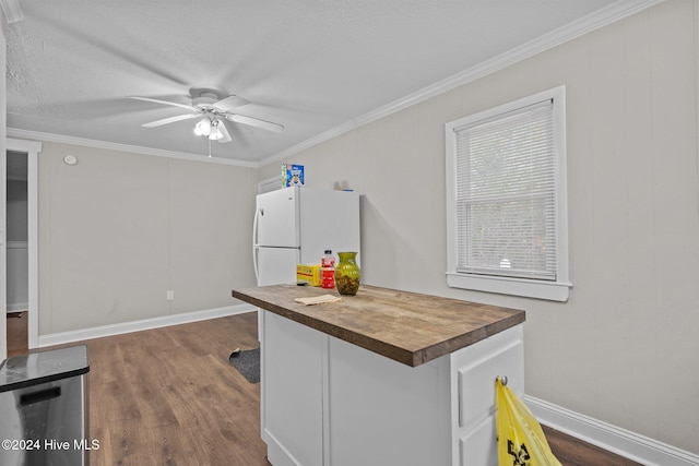 kitchen with butcher block countertops, dark hardwood / wood-style floors, white refrigerator, and ornamental molding