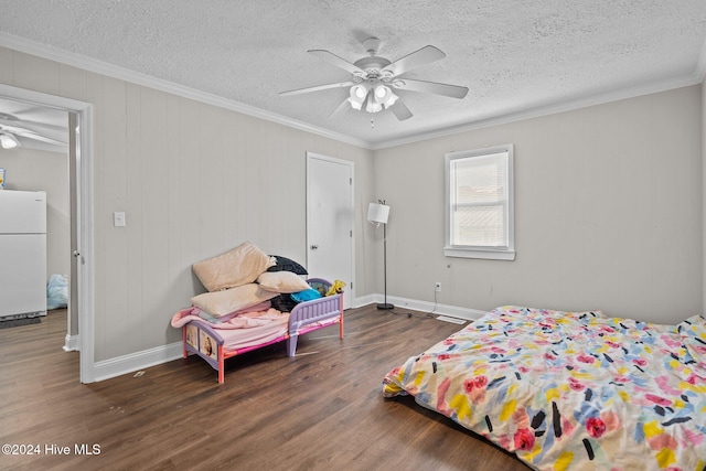 bedroom featuring ceiling fan, white fridge, dark hardwood / wood-style flooring, and ornamental molding