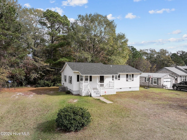 view of front of home featuring central AC, an outbuilding, a front lawn, and a porch