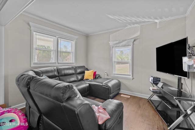 living room with ornamental molding, hardwood / wood-style flooring, and a healthy amount of sunlight