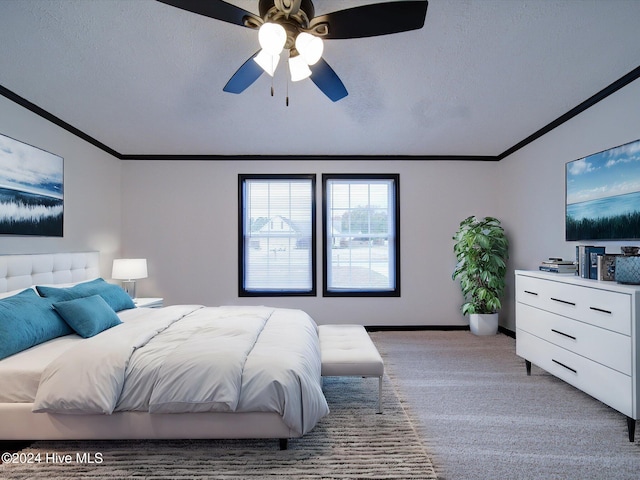 carpeted bedroom featuring ceiling fan, ornamental molding, and a textured ceiling