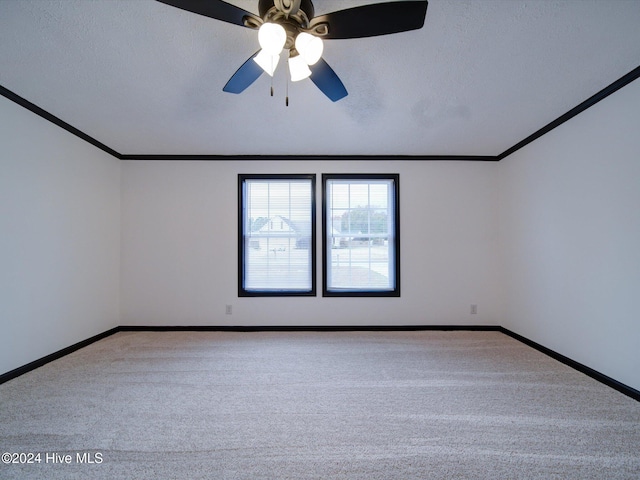 carpeted empty room with ceiling fan, crown molding, and a textured ceiling