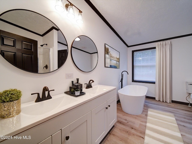 bathroom featuring separate shower and tub, wood-type flooring, a textured ceiling, and ornamental molding