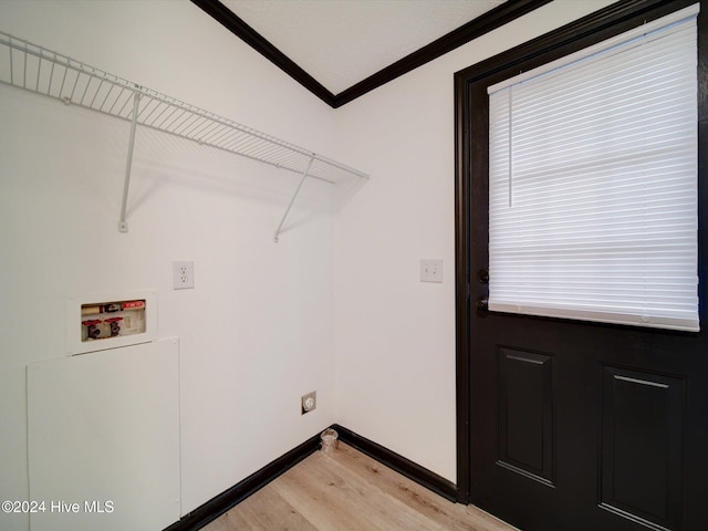 laundry room featuring washer hookup, a healthy amount of sunlight, light wood-type flooring, and ornamental molding