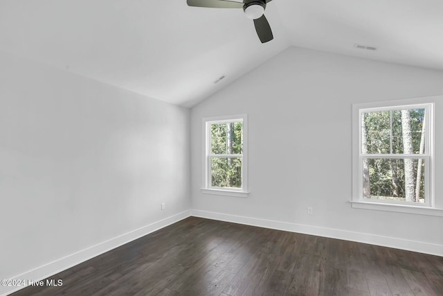 empty room featuring ceiling fan, dark hardwood / wood-style flooring, and vaulted ceiling