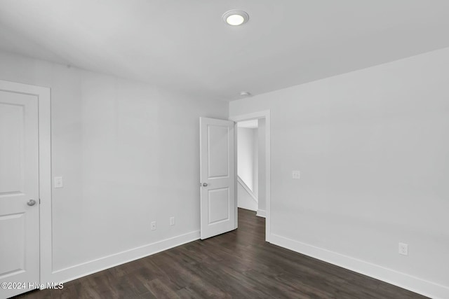 spare room with dark hardwood / wood-style floors