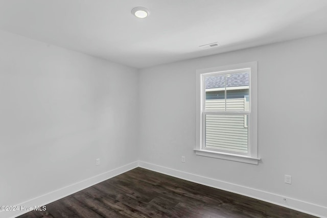 unfurnished room with dark hardwood / wood-style flooring