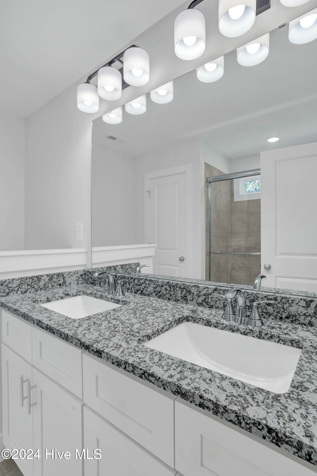 bathroom with vanity and an enclosed shower