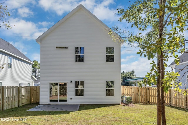 back of house with a patio area, a yard, and central AC unit