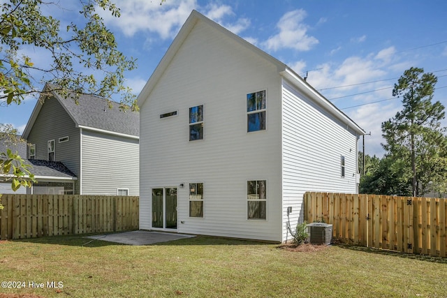 rear view of house with a yard, a patio area, and central air condition unit