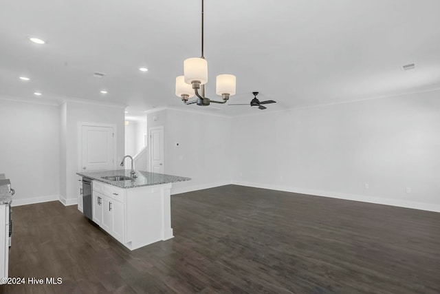 kitchen with light stone countertops, dark hardwood / wood-style flooring, sink, pendant lighting, and white cabinets