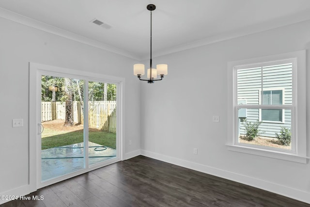 unfurnished dining area with dark hardwood / wood-style flooring, ornamental molding, a wealth of natural light, and a chandelier