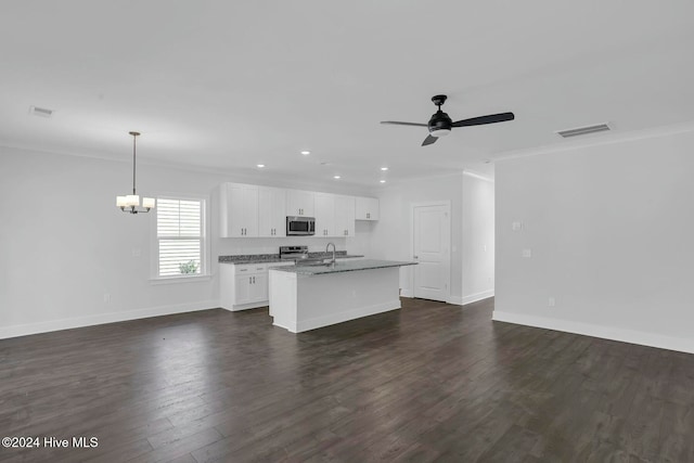 kitchen with dark hardwood / wood-style flooring, stainless steel appliances, decorative light fixtures, a center island with sink, and white cabinetry