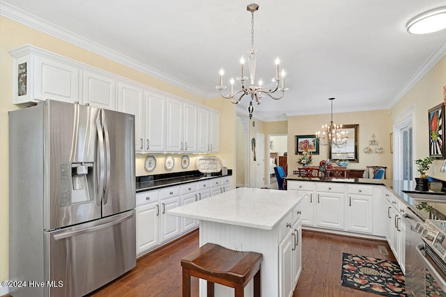 kitchen featuring a center island, dark hardwood / wood-style floors, kitchen peninsula, stainless steel fridge, and a chandelier