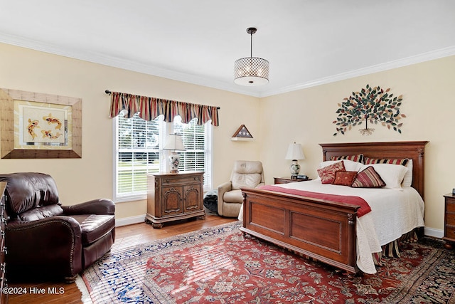 bedroom featuring hardwood / wood-style floors and ornamental molding