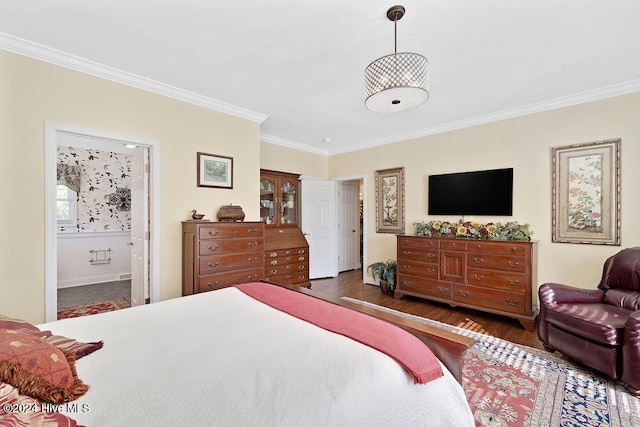 bedroom with dark wood-type flooring, crown molding, and ensuite bathroom