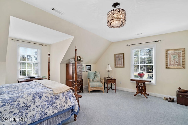 carpeted bedroom featuring multiple windows and lofted ceiling