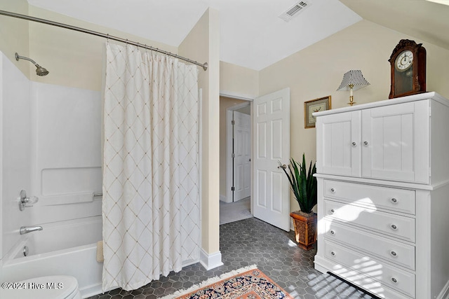 bathroom with tile patterned flooring, shower / bath combination with curtain, and toilet