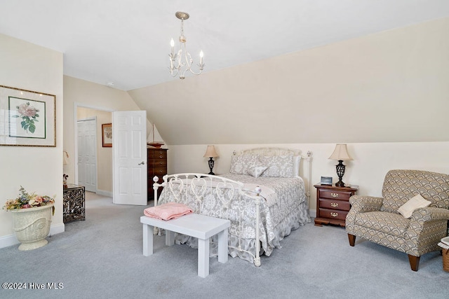 carpeted bedroom with a notable chandelier and lofted ceiling