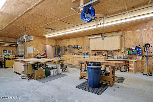 garage featuring a workshop area and wooden walls