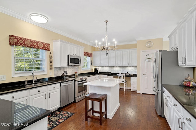 kitchen featuring sink, a center island, a healthy amount of sunlight, and appliances with stainless steel finishes