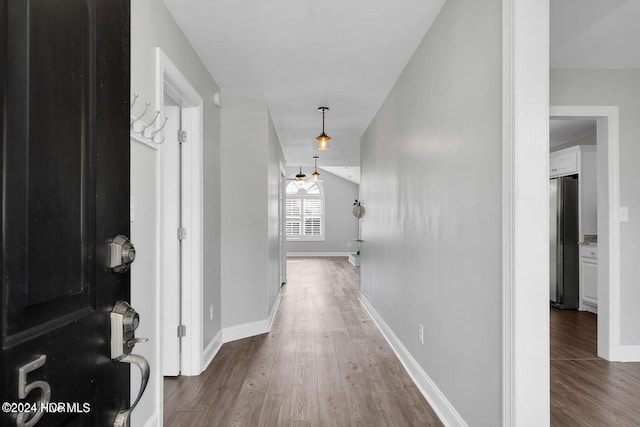 corridor with wood-type flooring