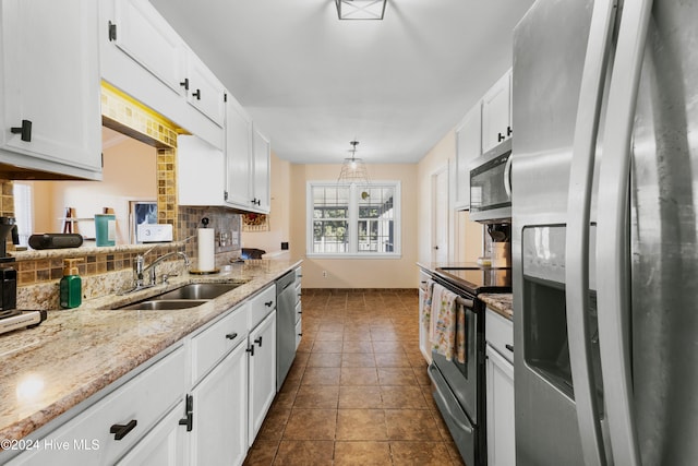 kitchen with white cabinets, sink, stainless steel appliances, and hanging light fixtures