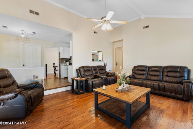 living room featuring ornamental molding, ceiling fan, hardwood / wood-style flooring, high vaulted ceiling, and beamed ceiling