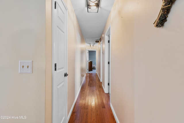 hallway with hardwood / wood-style floors