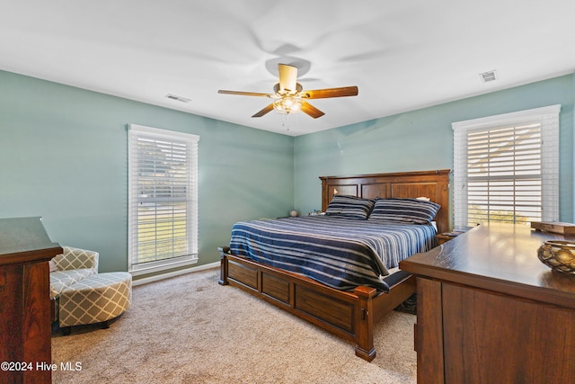 bedroom featuring ceiling fan and light colored carpet