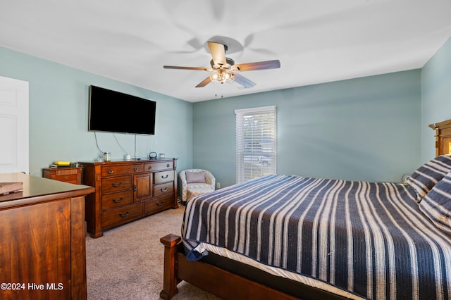 bedroom with light carpet and ceiling fan