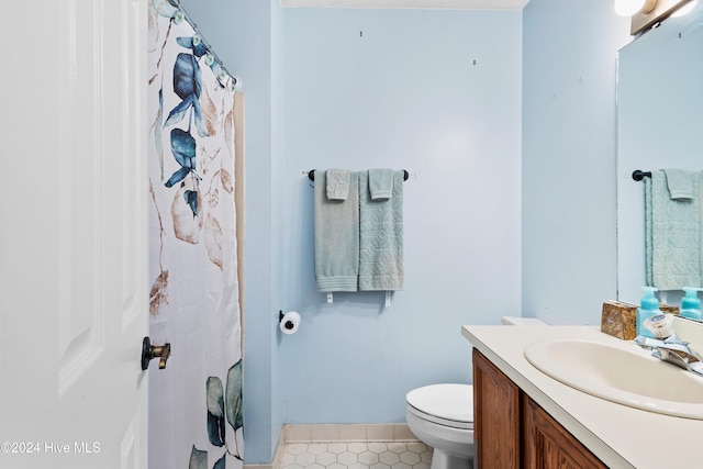 bathroom featuring tile patterned floors, vanity, toilet, and a shower with curtain