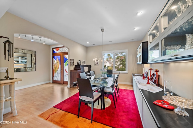 dining area featuring french doors and light wood-type flooring