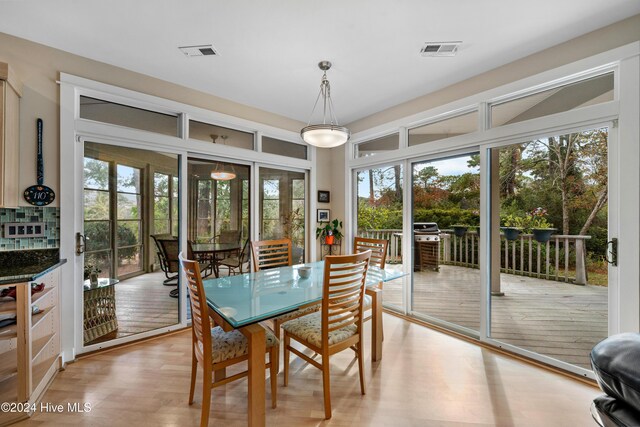 dining space featuring visible vents and light wood-style floors