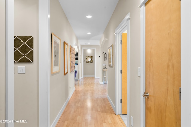 corridor with light hardwood / wood-style flooring