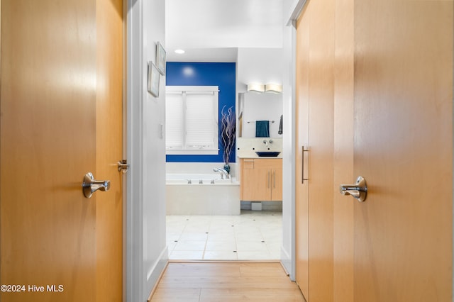 hallway featuring light hardwood / wood-style floors and sink