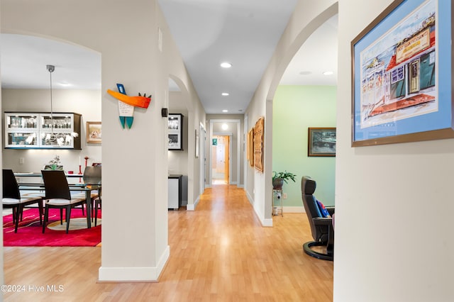 hallway with hardwood / wood-style flooring