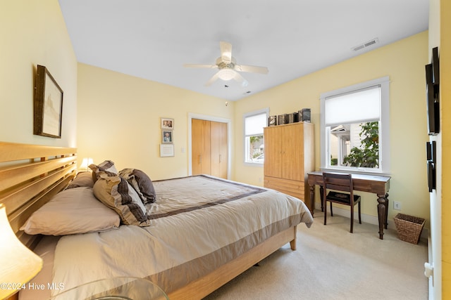 bedroom with light colored carpet and ceiling fan