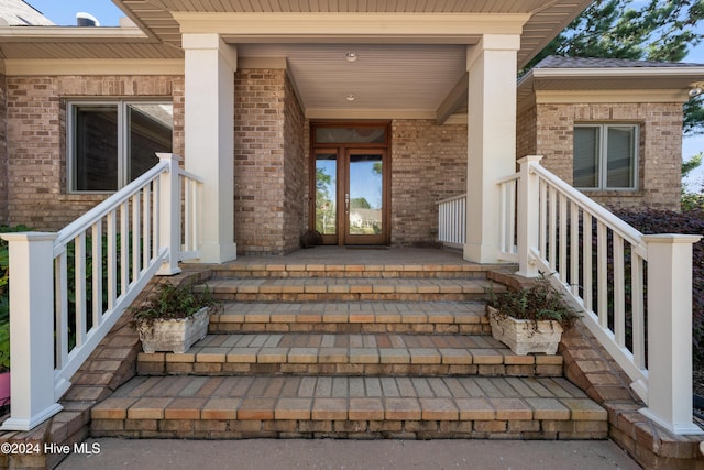 doorway to property with brick siding