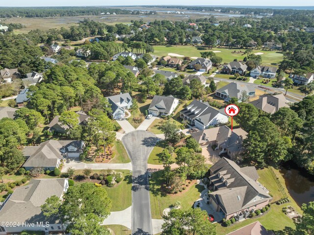 drone / aerial view featuring view of golf course and a residential view