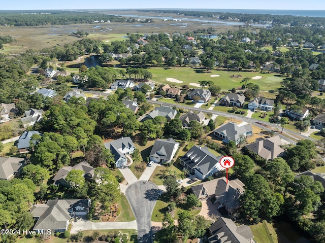 birds eye view of property featuring a water view, a residential view, and view of golf course