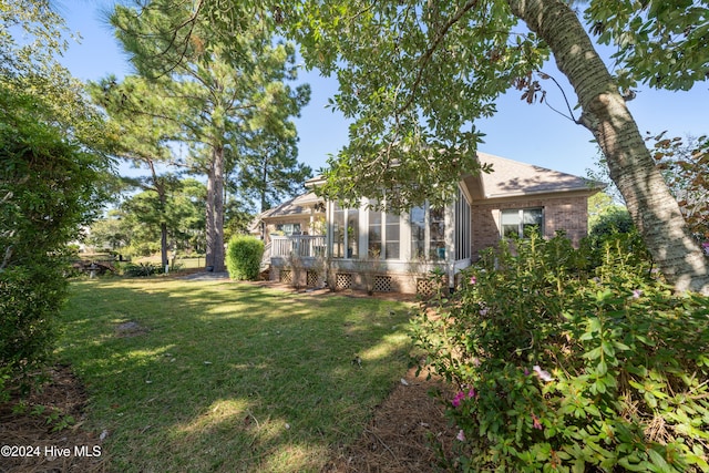 view of yard featuring a sunroom
