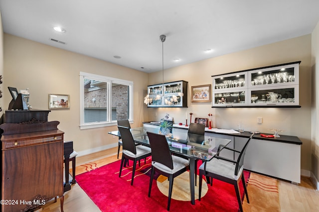 dining space with light hardwood / wood-style flooring