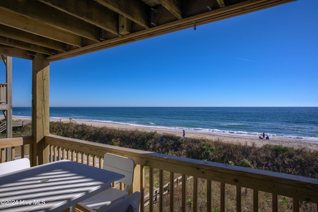 balcony with a beach view and a water view