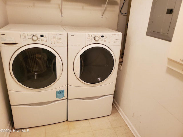 washroom with separate washer and dryer, electric panel, and light tile patterned floors